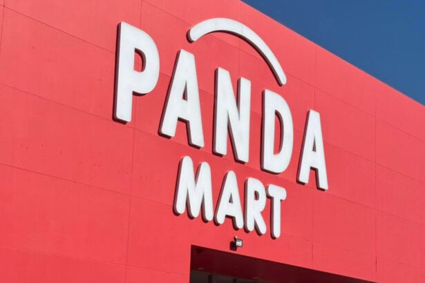 Exterior of a Panda Mart store, featuring the retailer’s white logo on a bright red facade against a blue sky.