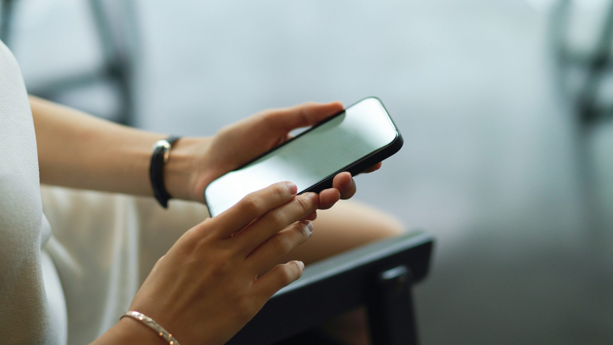 A person holding a smartphone in both hands.