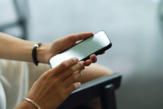 A person holding a smartphone in both hands.