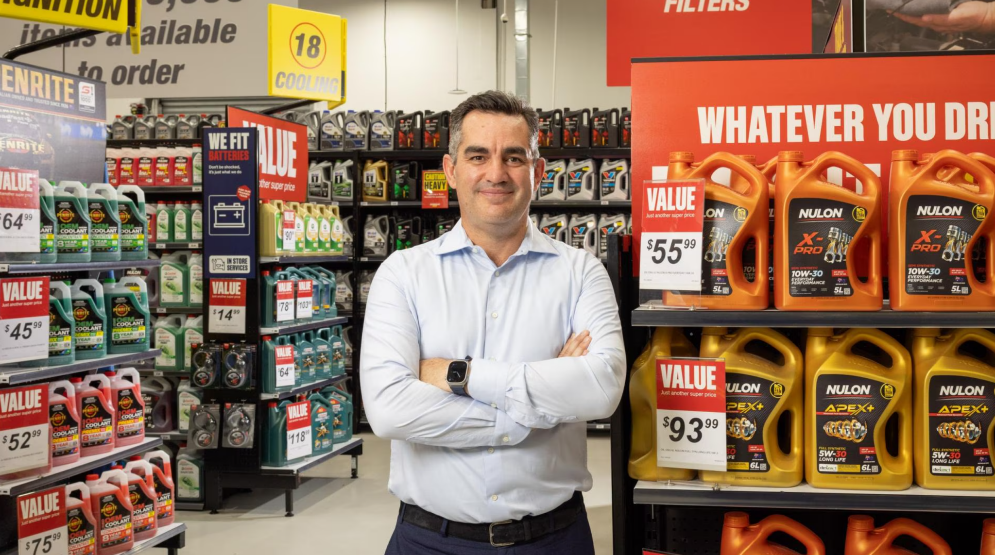 Former Super Retail Group CEO, Anthony Heraghty standing in Supercheap Auto store.