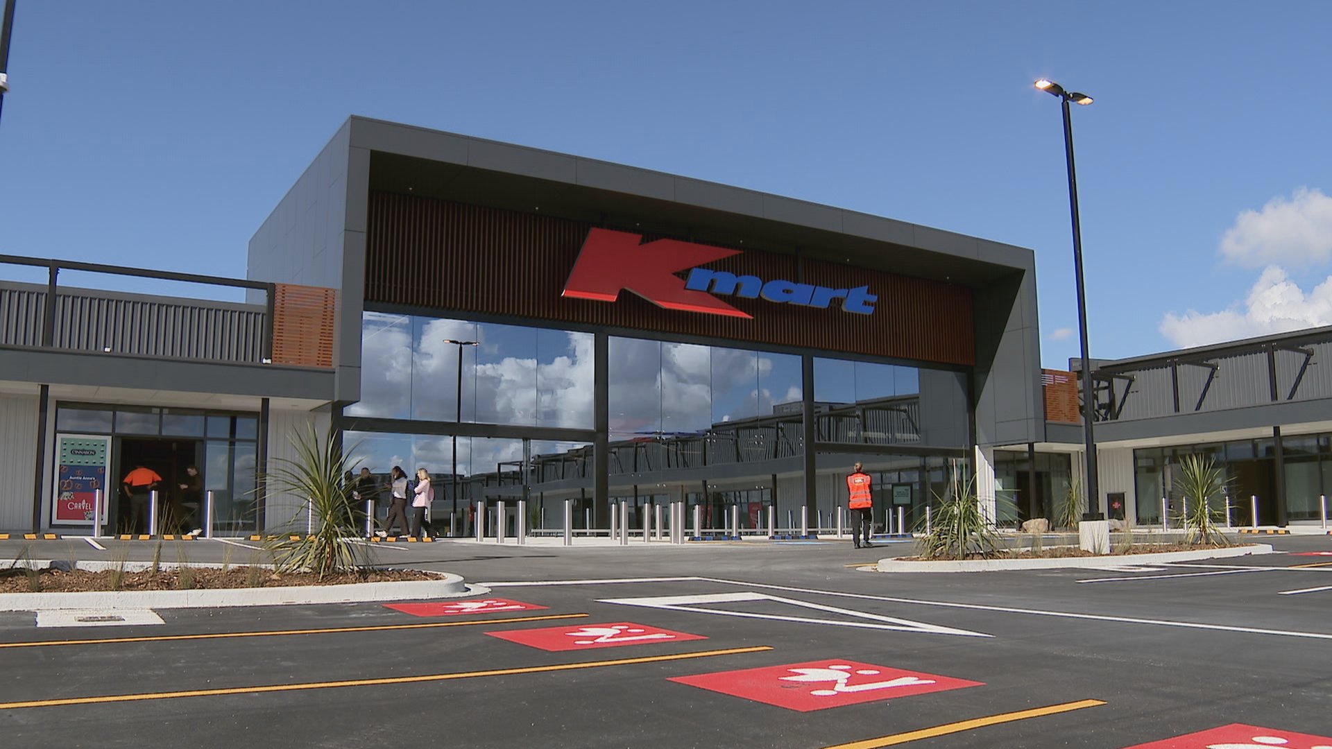 Exterior of a Kmart store with the Kmart logo above the main entrance.
