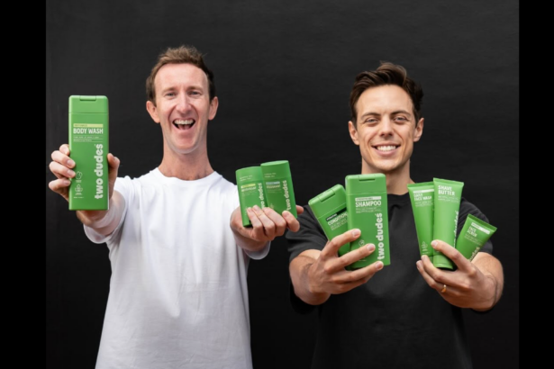 Two men holding a range of Two Dudes personal care products.