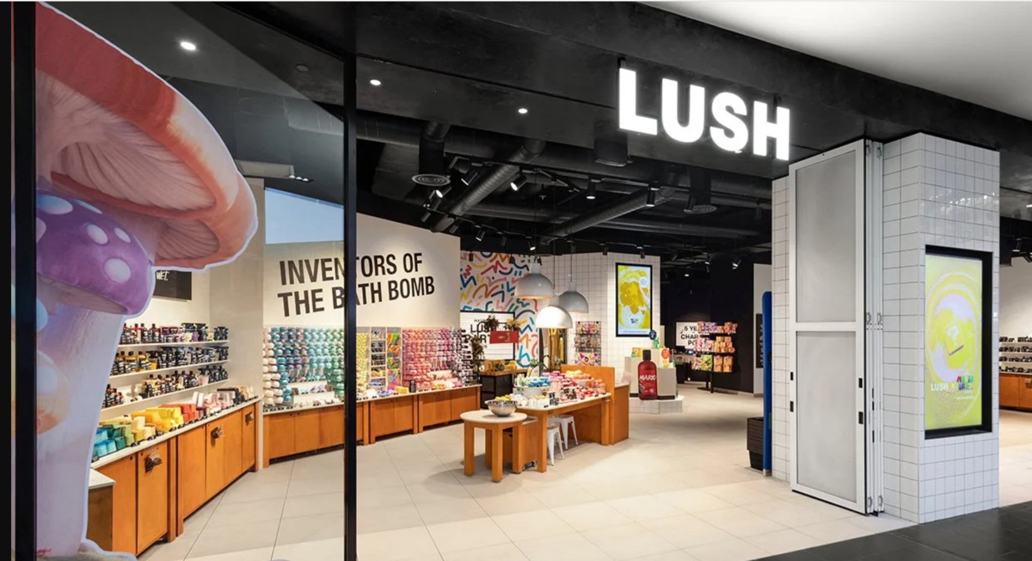 Lush cosmetics store at Melbourne Central, featuring illuminated signage, colourful bath products and wooden display counters.